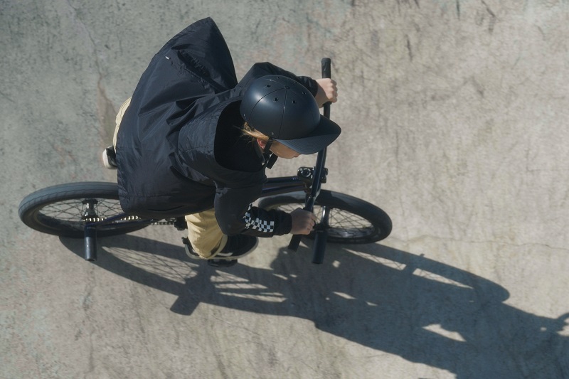 Why ProLids Helmets were Invented Overhead View of a Young Girl Wearing a ProLids Helmet Riding a Bike