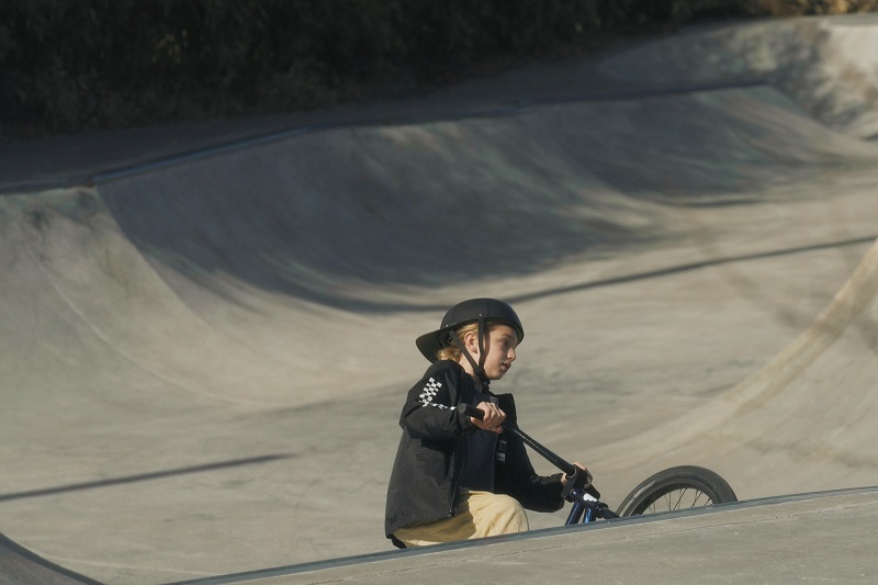 How to Adjust Helmets for a Better Fit Little Girl Riding a Bike in a Bike Park Wearing a ProLids Helmet