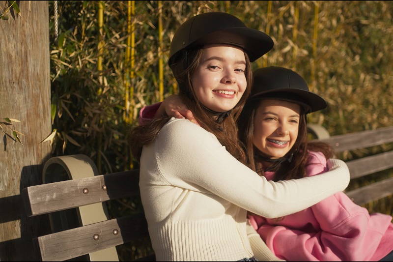 How to Get Kids Excited to Wear Helmets Two Young Girls Wearing proLids Helmets Sitting on a Park Bench