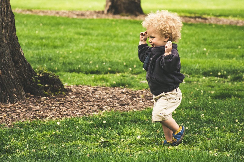 Balance Bike Tips for Toddlers a Toddler Running Through a Park