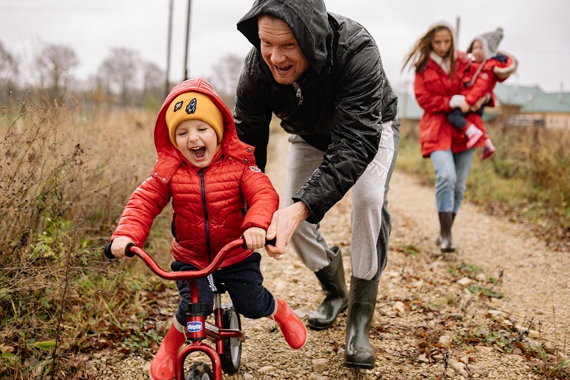 Balance Bike Tips for Toddlers a Family Teaching Their Toddler to Ride a Balance Bike on a Trail