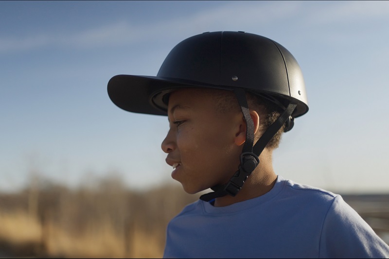 Helmet Strap Features a Young Boy Wearing a ProLids Helmet