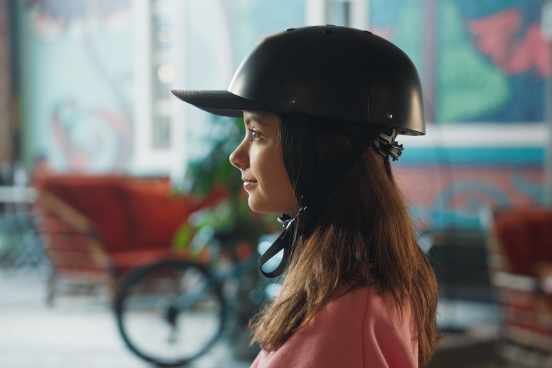 Helmet Strap Features a Young Girl Wearing a ProLids Helmet Inside