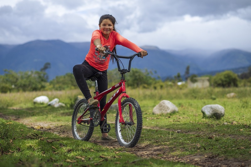 How to Size a Bike for Your Child a Young Girl Sitting on a Bike on a Field