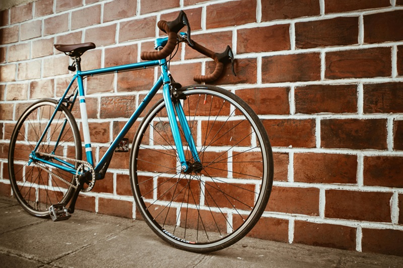 Bike Maintenance Tips for the Family a Blue Bike Leaning Up Against a Brick Wall