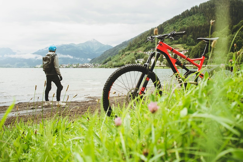 Bike Maintenance Tips for the Family a Person Standing on a Beach Looking Out at Water with a Bike Behind Them