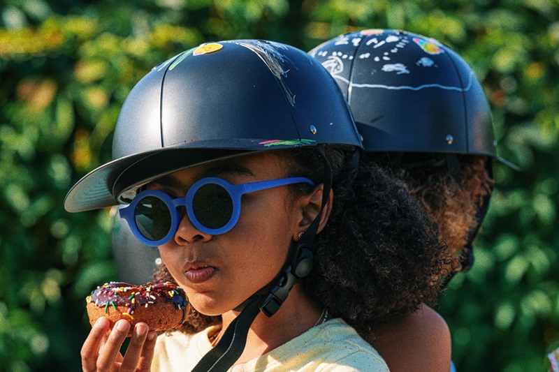 5 Things to Know about Materials Used in Helmets Two Young Girls Standing Back to Back Eating Donuts and Wearing ProLids Helmets