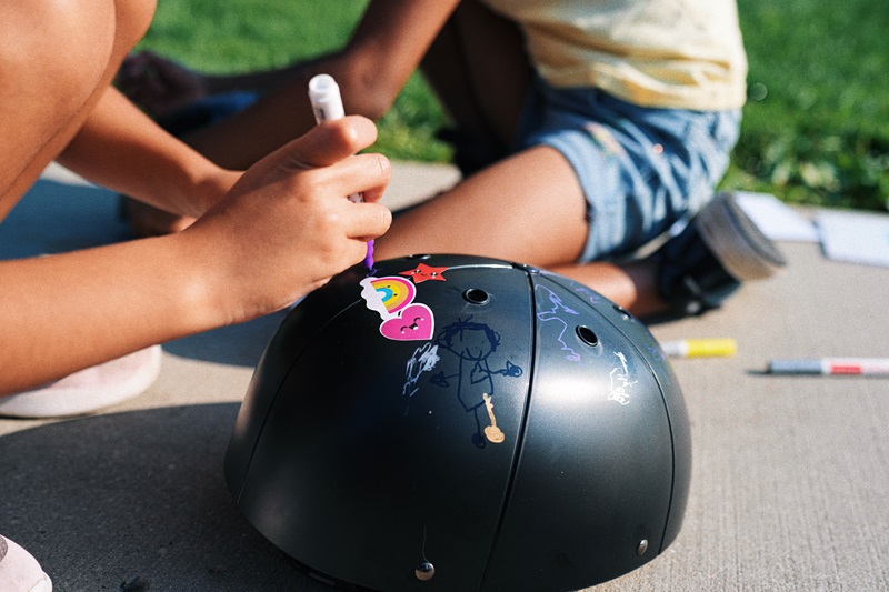 5 Things to Know about Materials Used in Helmets Close Up of a ProLids Helmet Being Drawn on by a Young Girl