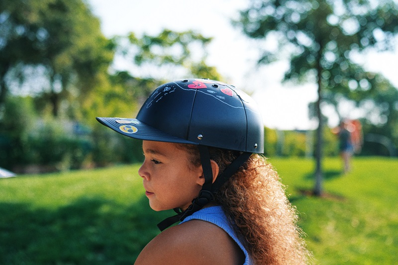 5 Things to Know about Materials Used in Helmets a Young Gril Riding a Scooter While Wearing a ProLids Helmet