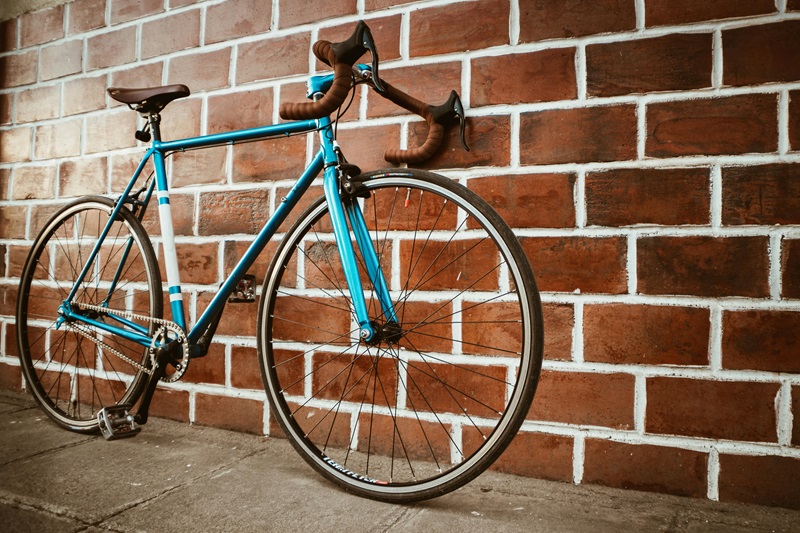 Best Bike Trails in Minnesota a Blue Bike Leaning Up Against a Brick Wall