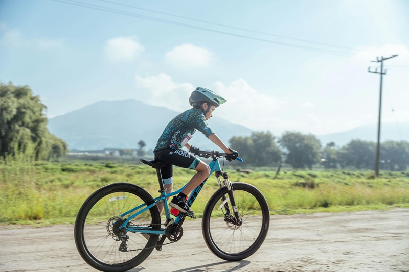 Types of Helmets for Kids a Kid Riding a Bike While Wearing a Regular Helmet