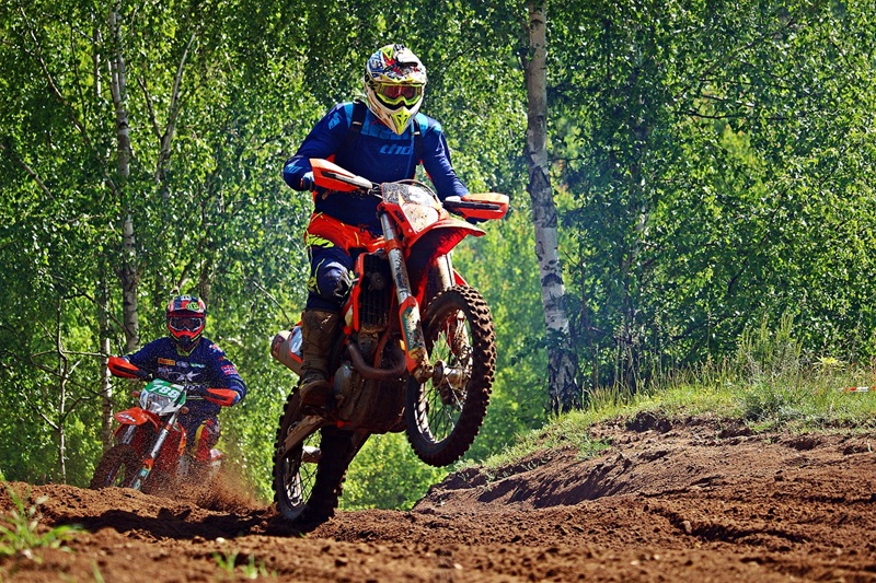 Best Dirt Biking Lessons for Kids in San Francisco Two People Riding Dirt Bikes on a Dirt Trail with Trees in the Background