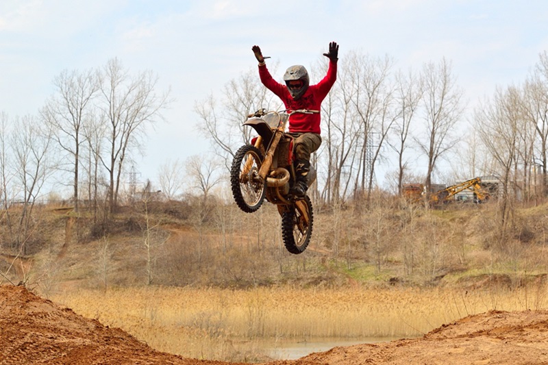 Best Dirt Biking Lessons for Kids in San Francisco a Person on a Dirt Bike in Mid Air After a Jump with Their Hands in the Air