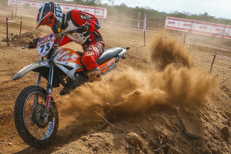 Tucson Dirt Biking Lessons a Person Riding a Dirt Bike on a Dirt Track with Dirt Flying Underneath the Bike